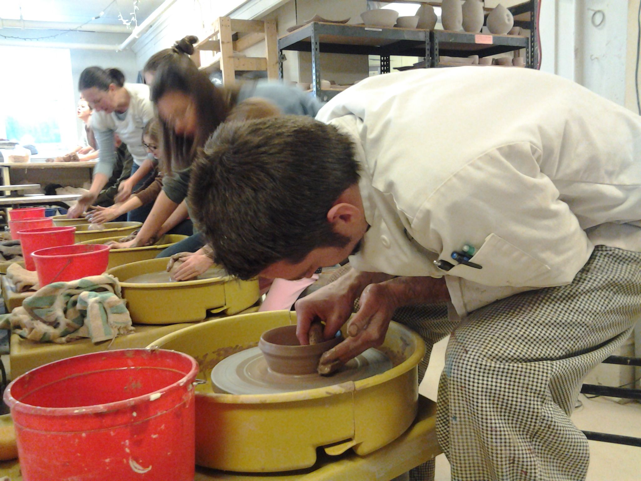 people making clay bowls