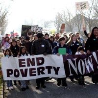 people marching with end poverty now! banner