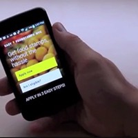 hand holding a smartphone running a food stamp application app