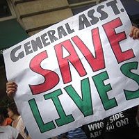 Protester holding sign: Geneal Asst. Save Lives