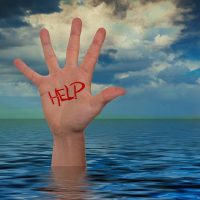 person raising hand out of ocean for help (via pixabay/Gerd Altmann)